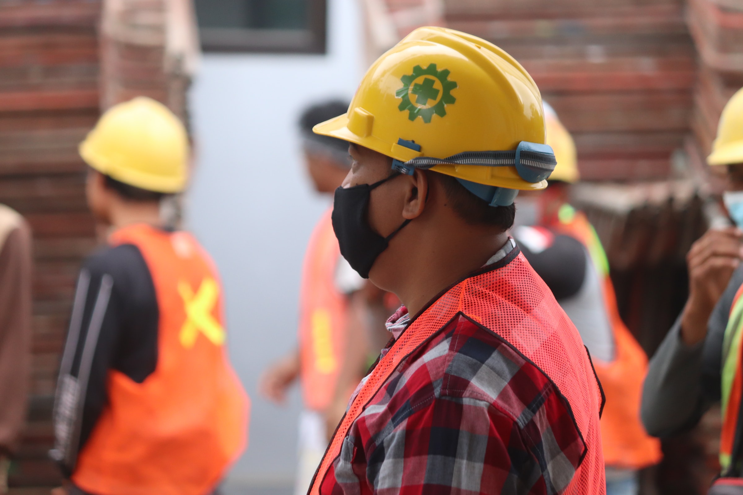 construction workers wearing masks and helmets